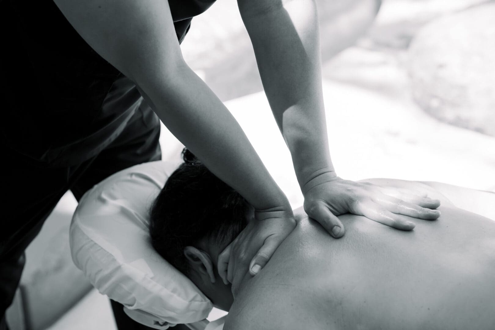 A person receiving a back massage in a calm setting.